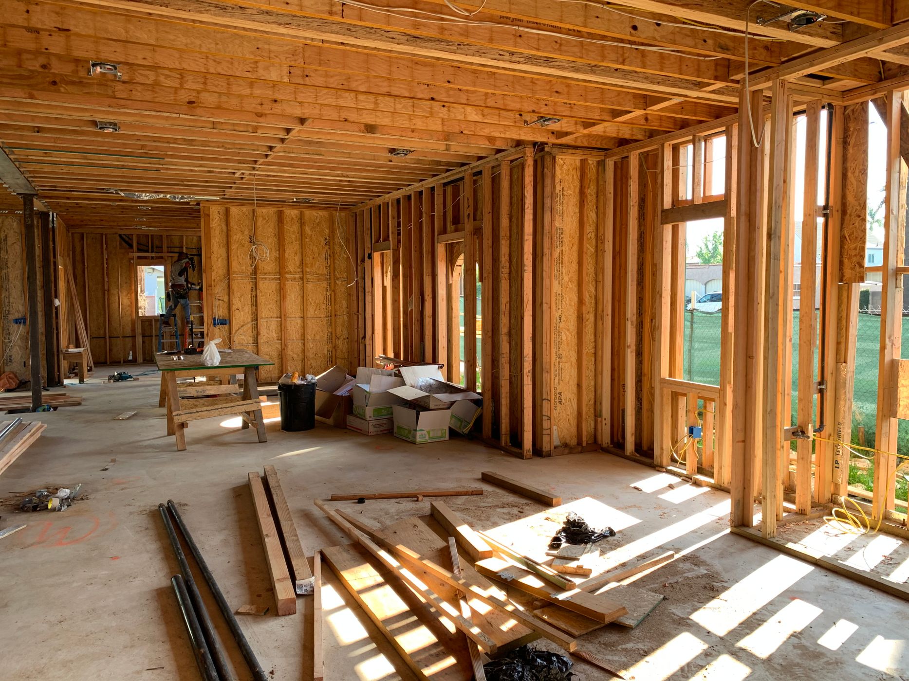 Sunlit residential wood framing in a home under construction